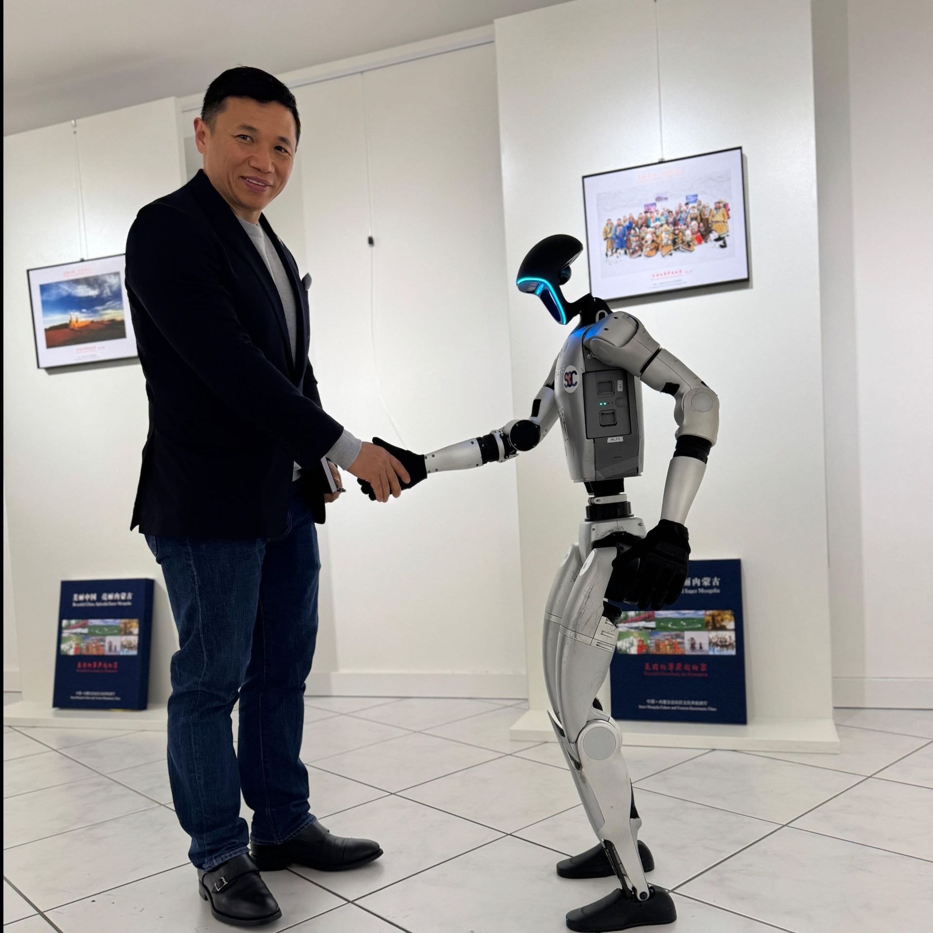 SCTCC representative shaking hands with a humanoid robot